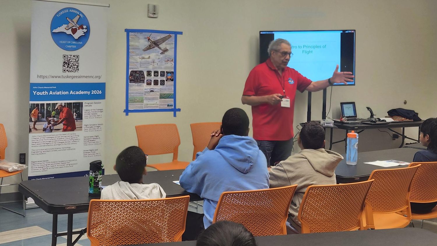 An instructor presents Intro to Principles of Flight to students at the Youth Aviation Academy