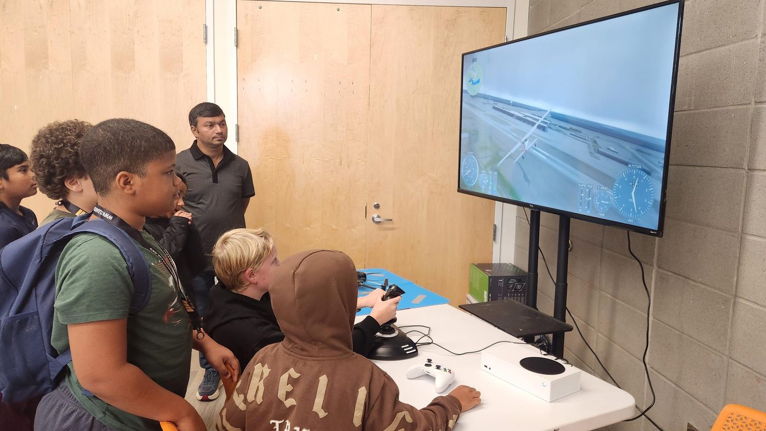 A student flying a landing on the desktop flight simulator