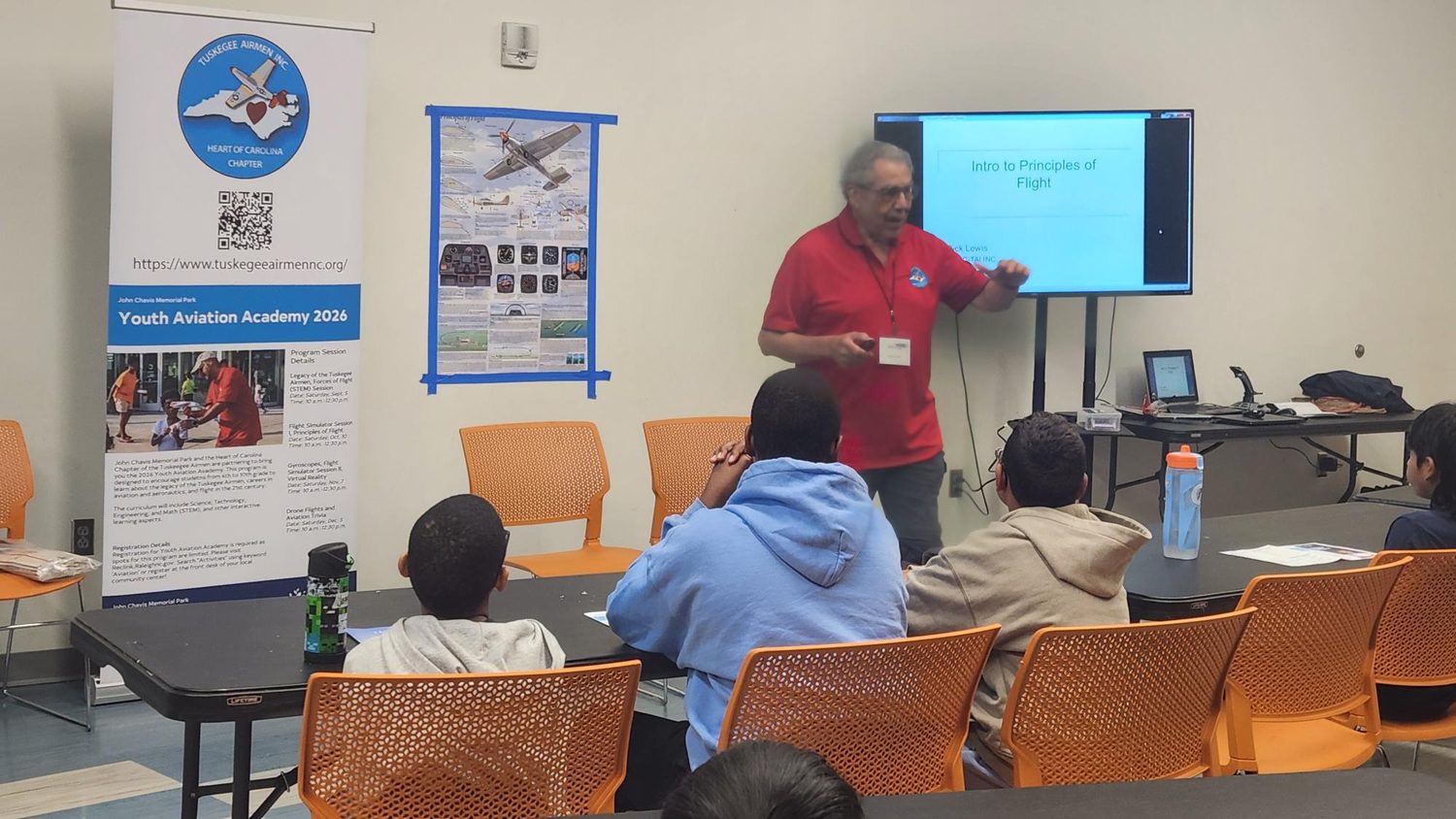 An instructor explains the forces of flight to students at the Youth Aviation Academy
